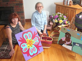 Linda Champagne, left, and Joanna Seitz, members of Kingston Grandmother Connection, display some of the items that will be on sale during a fair May 7. The organization raises money for African grandmothers who are looking after their grandchildren after their parents died of AIDS. (Michael Lea/The Whig-Standard)
