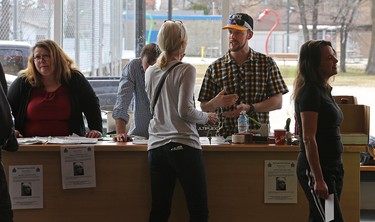 Scott Curtis (second from right) assists a volunteer searcher at the Sturgeon Heights Community Centre on Wed., April 27, 2016. The club is being used as headquarters in the community search for Scott's mother, Cathy Curtis, who went missing in the St. James area of Winnipeg on Monday. Kevin King/Winnipeg Sun/Postmedia Network