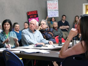 Chair of the board of the Kingston Frontenac Public Library Claudette Richardson, right, listens as Libraries Are For Everyone group member Julia Bryan speaks at a library board meeting on Wednesday. (Steph Crosier/The Whig-Standard)