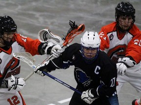 Point Edward Pacers Peyton Cox, left, and Matt Vince keep London Blue Devils captain Kingsley Doxtator in check during the junior B lacrosse game on Wednesday, April 27, 2016 in Point Edward, Ont. The teams crossed paths for the first time this season. (Terry Bridge/Sarnia Observer/Postmedia Network)