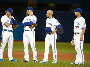 A glum looking group of Blue Jays fielders (from left to right) Josh Donaldson, Troy Tulowitzki, Ryan Goings and Matt Dominguez stand around after Dioner Navarro of the White Sox hit a triple at the Rogers Centre in Toronto on Wednesday, April 27, 2016. (Michael Peake/Toronto Sun)