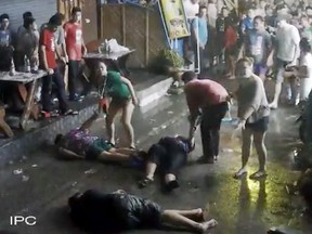 In this April 13, 2016 image taken from video released by the Hua Hin Municipality, an elderly British couple and their son are on the ground after they were savagely attacked during a family vacation in Hua, Hin, Thailand. (Hua Hin Municipality via AP)