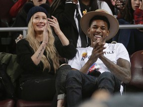 In this Jan. 14, 2015, file photo, Los Angeles Lakers guard Nick Young, right, and Australian recording artist Iggy Azalea attend an NCAA basketball game between UCLA and Southern California in Los Angeles. (AP Photo/Jae C. Hong, File)
