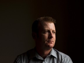 Derek Huff, a 10-year EPS veteran who resigned in February, is pictured with his de-commissioned badge in his home in Edmonton, Alta. on Tuesday, Oct. 1, 2013.  Amber Bracken