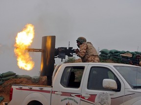 Iraqi security forces and allied Popular Mobilization forces fire towards positions in the Islamic State-held town of Besher, during a military operation to regain control of the small town outside the oil-rich city of Kirkuk, Iraq, 180 miles (290 kilometres) north of Baghdad in this April 10, 2016 file photo. According to Iraqi judicial authorities, ISIS is offsetting its lower oil income by running car dealerships and fish farms in Iraq. (AP Photo/Anmar Khalil)