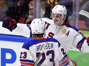 United States centre Auston Matthews, back, celebrates a goal with teammate Brock Boeser during preliminary-round action at the World Junior Championship in Helsinki, Finland, on Saturday, Dec. 26, 2015. (THE CANADIAN PRESS/Sean Kilpatrick)