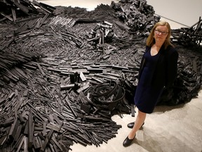 Jan Allen, director of the Agnes Etherington Art Centre at Queen' University, stands next to artist Joan Scaglione's work Face of the Deep.
(Elliot Ferguson/The Whig-Standard)