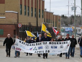 This Daily Press file photo shows workers representing every union and every industry in Timmins taking part in a brief march to the Timmins Miners Memorial in April 2016 to mark the National Day of Mourning.