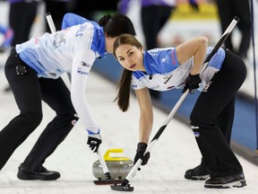 Sarah Daniels (left) and Karlee Burgess with Team Fay sweep during the Grand Slam of Curling 2016 Humpty’s Champions Cup play versus Team Rocque on Thursday at Sherwood Park Arena Sports Centre in Sherwood Park. (Ian Kucerak)