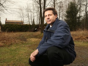 Bob Medwenitsch kneels in front of a parcel of land he owns in Osgoode. It has been the subject of a long-running dispute with bylaw and it is the last thing he and his wife, Laura (who suffered two strokes last year), need, he says.