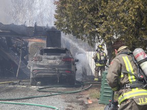 Greater Sudbury Fire Services firefighters responded to a blaze at 2010 Caribour Court in New Sudbury, Ont. on Thursday April 28, 2016. The blaze apparently started from a vehicle then quickly spread to the carport and home. Gino Donato/Sudbury Star/Postmedia Network