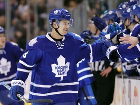 Toronto Maple Leafs defenceman Connor Carrick (8) gets congratulated at the bench after scoring the winning goal against the Buffalo Sabres at the Air Canada Centre March 19, 2016. (John E. Sokolowski-USA TODAY Sports)