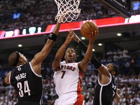 Toronto Raptors point guard Kyle Lowry (7) goes to the basket against Brooklyn Nets forward Paul Pierce (34) in Game 1 of the first round of the 2014 playoffs at the Air Canada Centre. (Tom Szczerbowski/USA TODAY Sports)