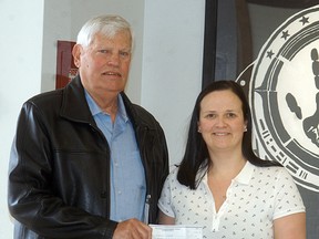 Wallaceburg Sports Hall of Fame's Tom Ayres donates $1,500 to Wallaceburg District Secondary School athletic director Janine Day. The money will go towards the renovation of the school's new fitness centre. An anonymous WDSS alumnus donated $1,000, with the Sports Hall of Fame kicking in another $500.