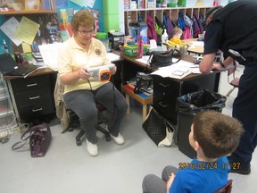 Stony Plain Lion’s club member Joan Lubbers conducting a vision screening of a kindergarten student in Parkland County - Photo submitted.