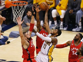 Pacers forward Paul George (13) shoots the ball as Raptors centre Jonas Valanciunas (17) defends during first quarter action in Game 6 of the first round NBA playoff series in Indianapolis on Friday, April 29, 2016. (Brian Spurlock/USA TODAY Sports)