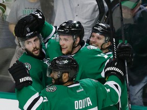 Stars centre Radek Faksa (12) celebrates his goal with teammates Antoine Roussel (21), Jason Demers (4) and Johnny Oduya (47) during the third period in Game 1 in the second round NHL playoffs series against the Blues in Dallas on Friday, April 29, 2016. (LM Otero/AP Photo)