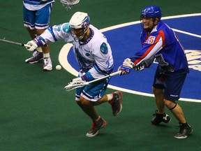 Turner Evans of the Toronto Rock (right) tangles with Scott Campbell of the Rochester Knighthawks during NLL action at the Air Canada Centre in Toronto on Jan. 14, 2016. (DAVE ABEL/Toronto Sun files)