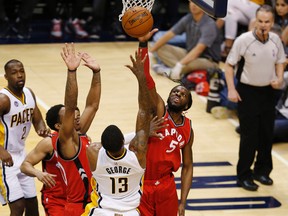 Raptors forward DeMarre Carroll (5) blocks the shot by Pacers forward Paul George (13) during the second half in Game 6 of the first round NBA playoff series in Indianapolis on Friday, April 29, 2016; . (Brian Spurlock/USA TODAY Sports)