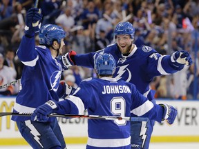 Tampa Bay Lightning defenceman Victor Hedman is congratulated by centres Tyler Johnson and Brian Boyle after scoring a goal during the second period of Game 2 of the NHL's Eastern Conference semifinals against the New York Islanders in Tampa on April 30, 2016. (AP Photo/Chris O'Meara)