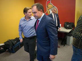 Ottawa Senators general manager Pierre Dorion walks out of the media centre after holding a press conference on April 4, 2016, the day he dismissed the coaching staff. (WAYNE CUDDINGTON/Postmedia)