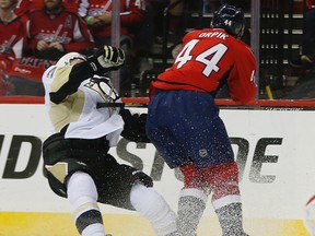 Washington Capitals defenceman Brooks Orpik (44) levels Pittsburgh Penguins defenceman Olli Maatta (3) with a high hit during the first period of Game 2 in an NHL hockey Stanley Cup Eastern Conference semifinals Saturday, April 30, 2016 in Washington. Pittsburgh won 2-1. (AP Photo/Pablo Martinez Monsivais)