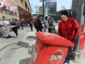 Brad Sweeney, readership specialist and retention manager at the Winnipeg Sun, wheels away after handing out free newspapers in front of Portage Place during the lunch hour on April 27, 2016.  (Kevin King/Winnipeg Sun/Postmedia Network)