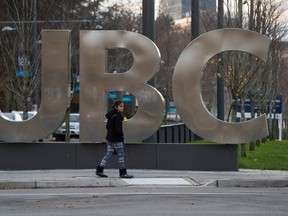A young woman walks past large letters spelling out UBC at the University of British Columbia in Vancouver, B.C., on Sunday, November 22, 2015. THE CANADIAN PRESS/Darryl Dyck