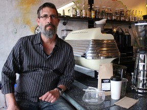 Dave Duguay, owner of Blackwater Coffee Company, displays the biodegradable coffee cups and food containers he uses in his downtown Sarnia coffee shop. His family-run business has won an inaugural Go Green Award for its environmental practices. (Barbara Simpson/The Observer/Postmedia Network)
