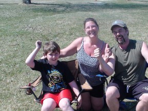 Roman Sikora, left, Claudine Sikora and Earl Sikora welcome news of the Winnipeg Jets No. 2 draft pick at a North End Winnipeg park on Sunday, May 1, 2016. (Jim Bender, Winnipeg Sun, Postmedia Network)