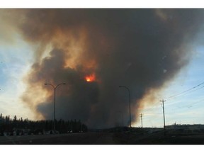 A forest fire burns as viewed from Highway 69 south of Fort McMurray, Alta., on Sunday May 1, 2016. (Robert Murray photo)