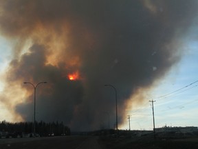 A forest fire burns as viewed from Highway 69 south of in Fort McMurray Alta. on Sunday May 1, 2016. Robert Murray/Fort McMurray Today/Postmedia Network