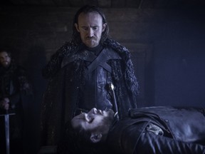This image released by HBO shows Ben Crompton, standing, and Kit Harington in a scene from the season six premiere of "Game of Thrones." Nielsen estimated that 7.94 million people watched "Game of Thrones" at 9 p.m. EDT Sunday, when the episode first aired. (Helen Sloan/HBO via AP)