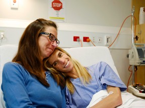 Carolyn Lloyd, left, of Charlotte, N.C., comforts her daughter Rachel at Wellington Hospital in Wellington, New Zealand, Monday, May 2, 2016. The American pair were rescued over the weekend in the New Zealand wilderness, where they were lost for five days after setting off on a day hike. A helicopter pilot spotted the large “help” signs they had made from fern fronds. (AP Photo/Nick Perry)