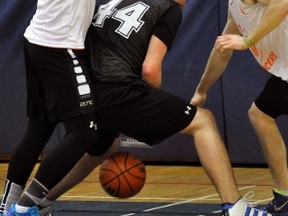 Wayne Otten (left) and Chris Wise of The Juicers double-team this Exeter opponent during action from the 13th annual Mitchell DHS alumni basketball tournament last Friday, April 29 at MDHS. All told, 10 teams participated in the tournament. ANDY BADER MITCHELL ADVOCATE