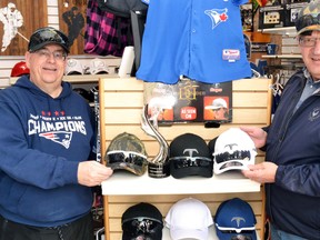 The innovative new TCap, a combined baseball hat and pair of adjustable sunglasses, can now be purchased at several locations throughout Mitchell, including The Stickhandler. Gus Eyers (left), owner of The Stickhandler, and TCaps Canadian distributor Rick O'Donnell pose with the silver trophy the TCaps won for most creative promotional product at the Promotional Product Professionals Canada Convention in Toronto in January. GALEN SIMMONS MITCHELL ADVOCATE