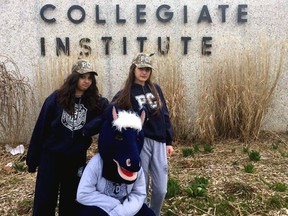 Grade 12 students Emilia Yuriaan, left, and Kayleigh Trowman pose with Stampy before his retirement later this month. A new Stampy will be joining the Parkside community in late May.]