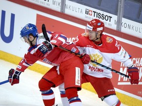 Russia's Nikita Zaitsev, right, tries to slow down Czech Republic's Tomas Filippi during their Euro Hockey Tour Karjala Cup match in Helsinki on Nov. 8, 2015. (Martti Kainulainen/Lehtikuva/Reuters)