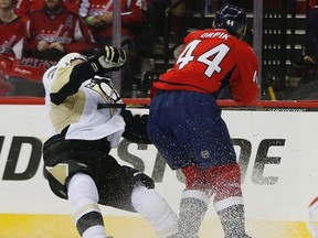 Capitals defenceman Brooks Orpik (right) levels Penguins defenceman Olli Maatta (left) with a hit to the head during the first period of Game 2 in an NHL playoff series Saturday, April 30, 2016 in Washington. (Pablo Martinez Monsivais/AP Photo)