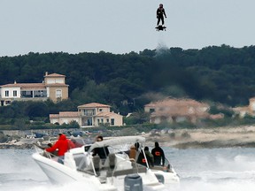 Pilot and jet-ski champion Franky Zapata hovers in the air on an IPU Flyboard Air hoverboard as he breaks the Guiness World Records for furthest flight by hoverboard, after covering a distance of 2,252.4 metres with an average speed of 50-60km/h, in Sausset les Pins near Marseille, France, April 30, 2016.  REUTERS/Jean-Paul Pelissier