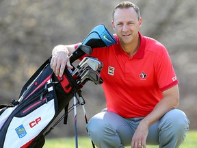 Derek Ingram, coach of the Canadian Olympic golf team, poses with his clubs in Winnipeg, Man. Monday May 2, 2016.