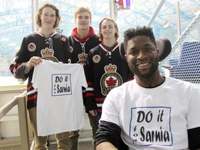 Dan Edwards poses with Legionnaires players in February at the official kick-off of his $150,000 Do it for Sarnia fundraising campaign. A Block Party event featuring country musician and Sarnia native Eric Ethridge is set for Friday. (File photo)