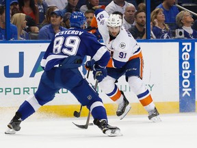 New York Islanders centre John Tavares skates with the puck as Tampa Bay Lightning defenceman Nikita Nesterov defends during the second period of Game 2 of the second round in the NHL playoffs at Amalie Arena in Tampa on April 30, 2016. (Kim Klement/USA TODAY Sports)