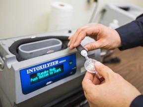 Const. Phil Gavin at the Niagara Regional Police detachment in St. Catharines with an Intoxilyzer 8000C breathalyzer February 18 2016. (Bob Tymczyszyn/Postmedia Network)