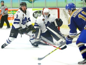 Caledonia?s Blake Luscombe looks for room to shoot through London Nationals goalie Connor Hughes and defenceman Derek Di Iorio during Game 4 of the Sutherland Cup final at Western Fair Sports Centre on Monday.  (Mike Hensen/The London Free Press)