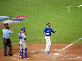 In this Oct. 14, 2015, file photo, Toronto Blue Jays' Jose Bautista flips his bat in the air while celebrating his three-run home run during the seventh inning in Game 5 of baseball's American League Division Series against the Texas Rangers in Toronto. (Darren Calabrese/The Canadian Press via AP, File)