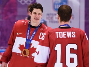 Sidney Crosby celebrates with teammate Jonathan Toews after beating Sweden in the final at the 2014 Winter Olympics in Sochi, Russia. (THE CANADIAN PRESS/Paul Chiasson)