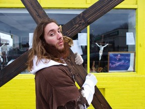 Michael Grant, 28, "Philly Jesus," poses for a portrait in front of a store window  in Philadelphia, Pennsylvania, in this December 20, 2014 file photo.  REUTERS/Mark Makela