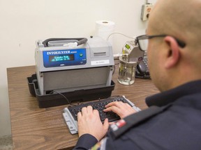 Const. Phil Gavin at the Niagara Regional Police detachment in St. Catharines with an Intoxilyzer 8000C breathalyzer February 18 2016. (Bob Tymczyszyn/Postmedia Network)