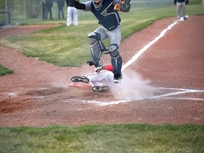 Mitchell Zoratti slides into home taking out the Flyers back catcher and gaining another run for the Hawks in the third inning. | Caitlin Clow photo/Pincher Creek Echo